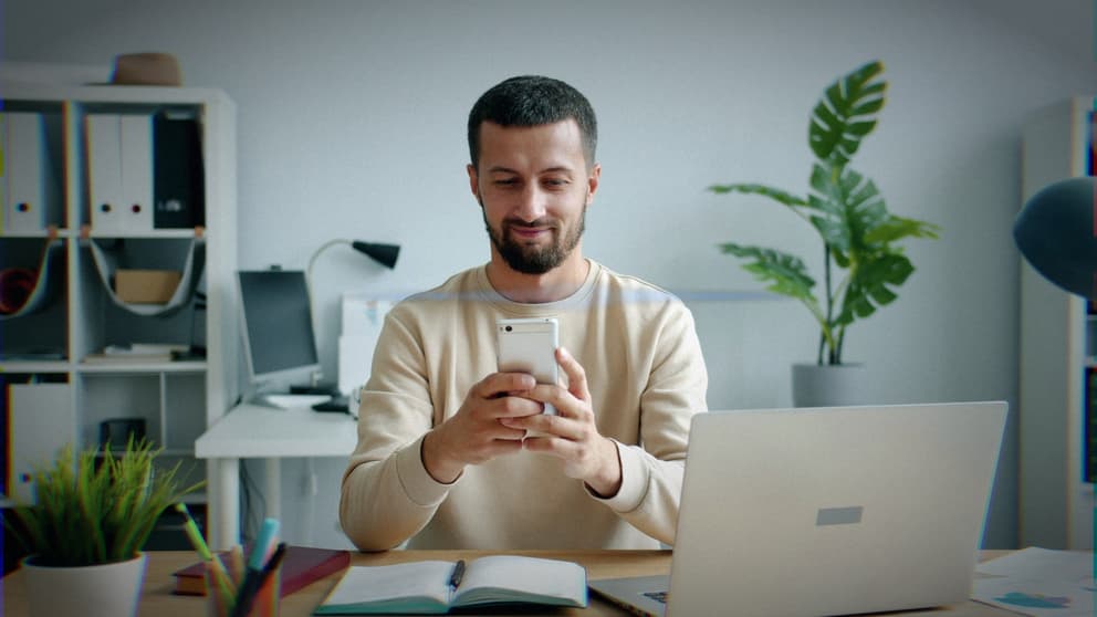 Photo-realistic shot of tech professional staring at phone in modern corporate architectural glass office